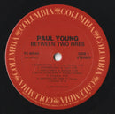 Paul Young - Between Two Fires (LP Tweedehands)